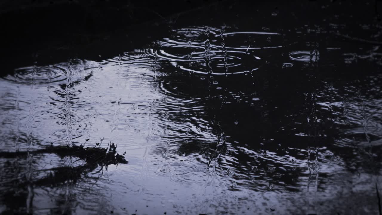 Heavy rain shower downpour cloudburst rainfall behind the glass.