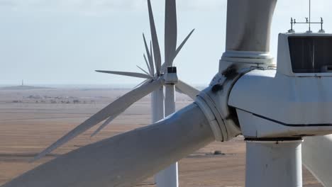 drone orbiting wind turbines, shot on telephoto lens