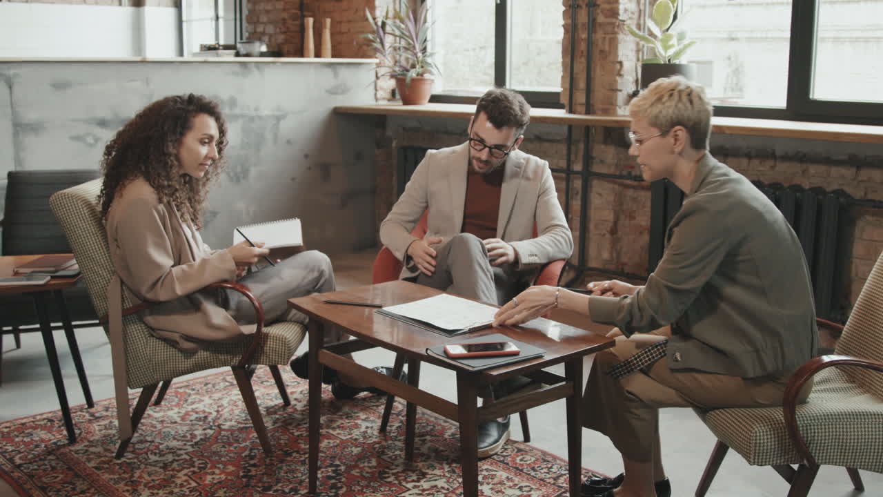 Business Partners Discussing Contract in Modern Coworking Office