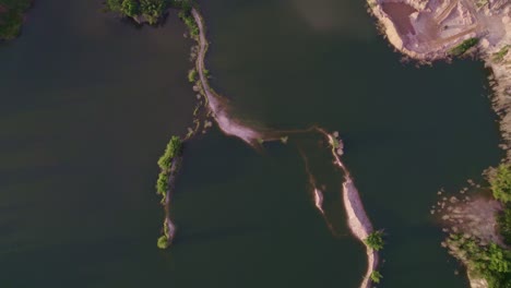 Drone-flying-over-a-lake-and-sand