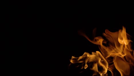 flames of fire on black background in slow motion