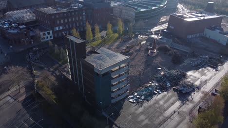 demolished multi storey car park concrete construction debris in town regeneration aerial rising view demolition site