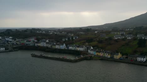 aerial orbit shot of roundstone beautiful town with colourful houses by the sea