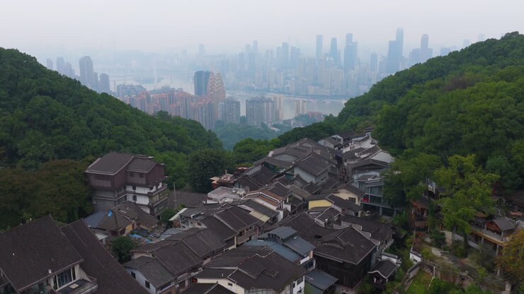 Huangjueya Old Street Overlooking The Modern City Of Yuzhong District In Chongqing, China. Aerial Shot
