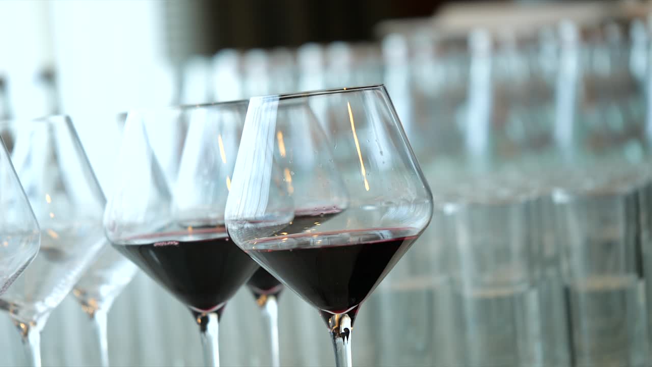 Gentle Hand Pick Up Transperent Glass Of Red Wine Out Of Other Glasses