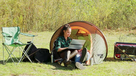 beautiful young girlfriend laughing while working on her laptop