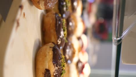 close-up of delicious glazed donuts with chocolate and pistachio topping