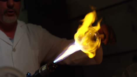 close-up of male worker blowing glass in glass factory 4k