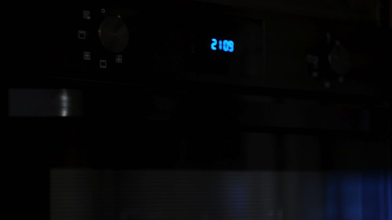 Woman Setting Oven Timer