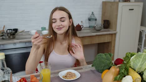 niña comiendo brotes crudos de trigo sarraceno con nueces en la cocina. pérdida de peso y dieta. estilo de vida saludable