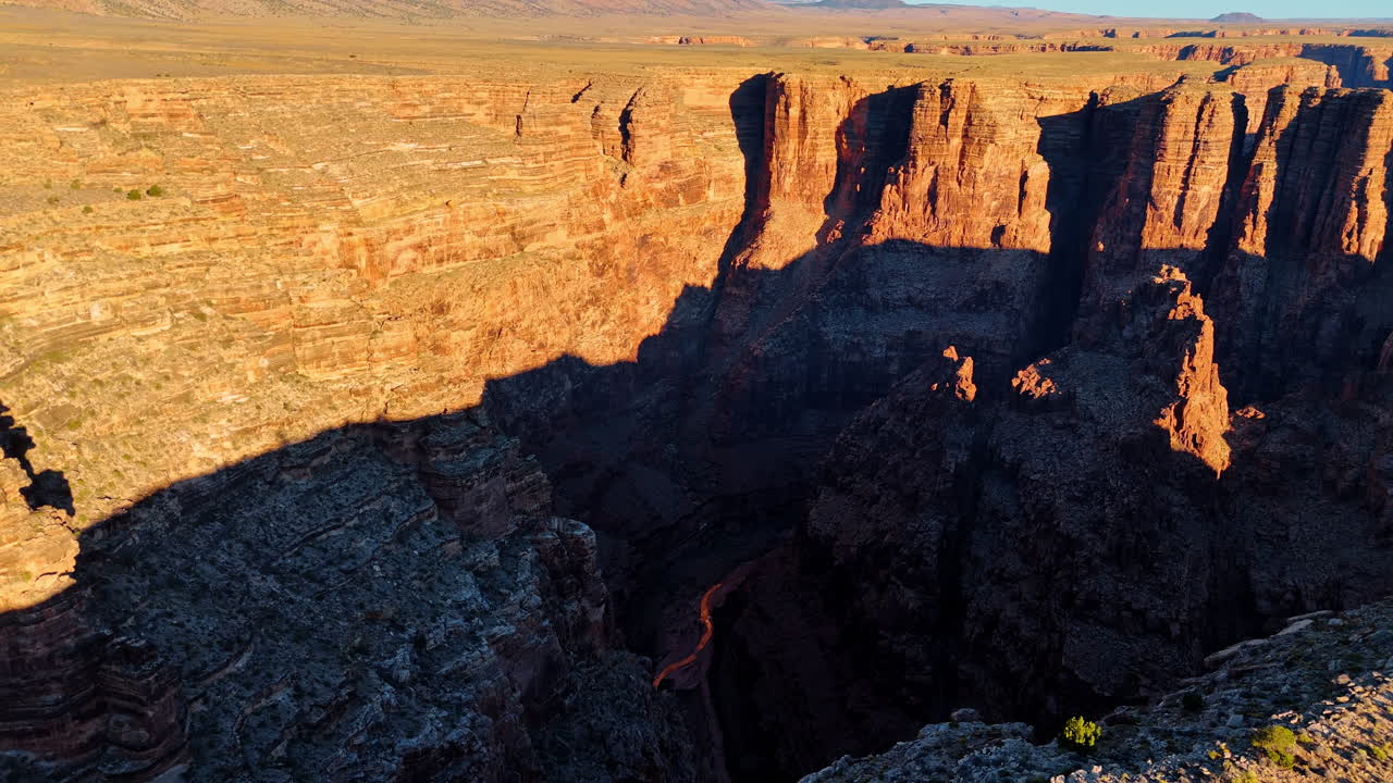 Flight over the deep dark canyon in Marble Canyon, Arizona, United States. Layered geological formations and impressive cliff walls