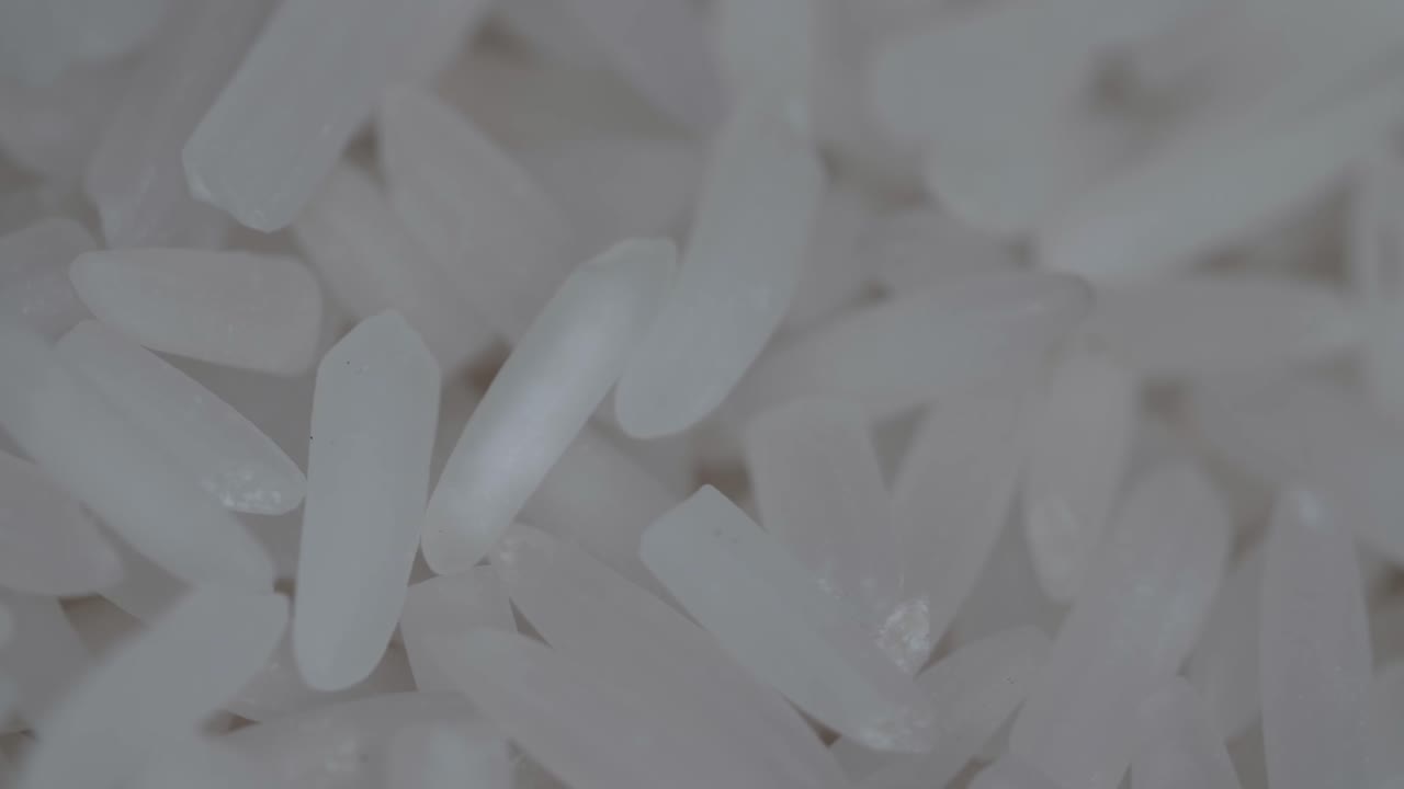 Raw White Rice Grain Rotating In A Slow Motion, Over White Background