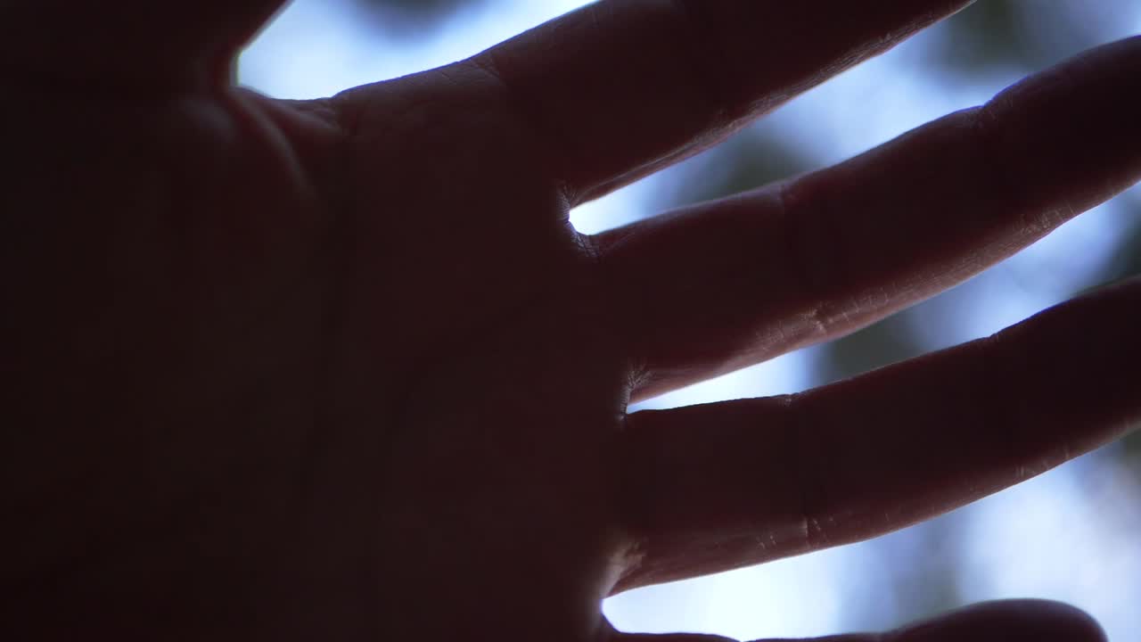 Single hand closing against bokeh lights background close up shot