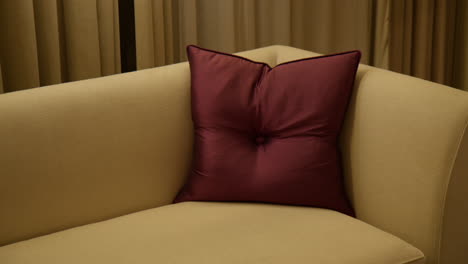 throw pillow on the couch inside a hotel room. close-up shot
