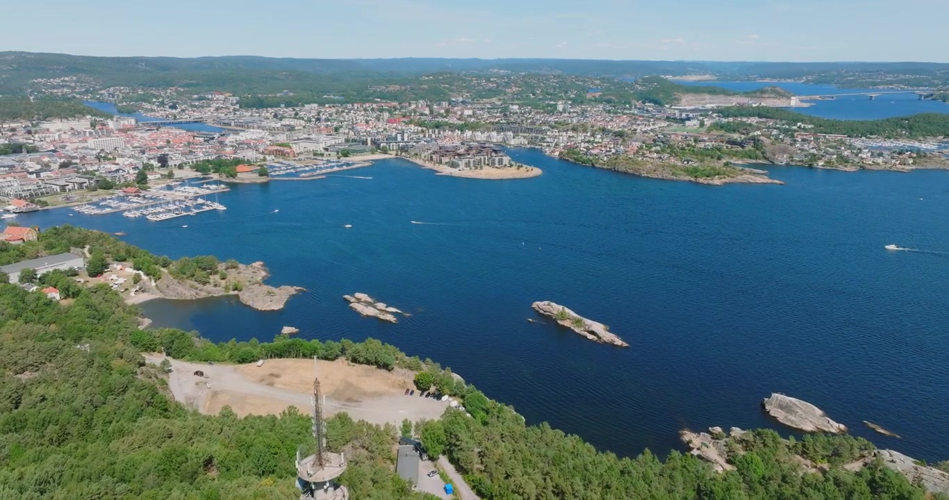 Ilmakuva Norjan Kristiansandin rannikkokaupungista, jossa näkyy risteilyalus ja ranta-alue.