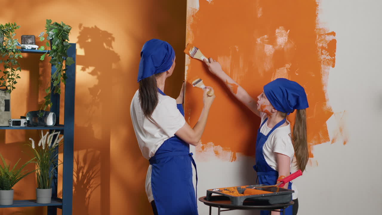 Mother and Daughter Painting a Wall Together