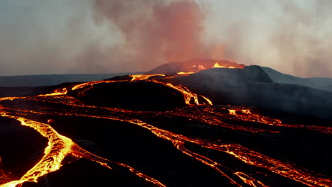 Fly-over-lava-flowing-down-from-crater.-Boiling-magma-in-active-volcano.-Aerial-view-before-sunrise.-Fagradalsfjall-volcano.-Iceland,-2021