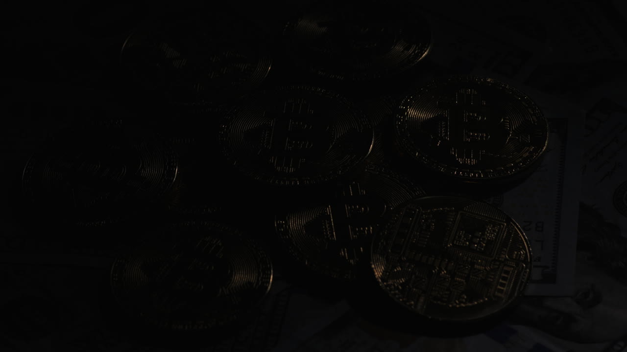 Several Coins Of Crypto Currency Bitcoin Against The Background Of American Dollars Crypto Currency 