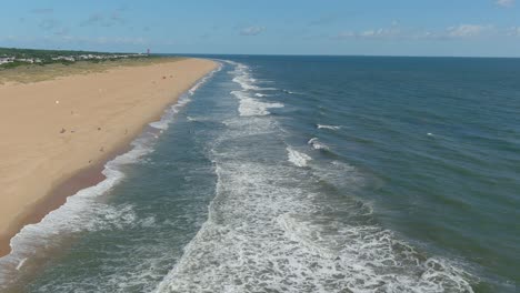 Drone-flight-along-Virginia-Beach-North-End,-looking-North-towards-the-Cape-lighthouse