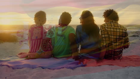 animación de una bandera española ondeando sobre un grupo de amigos diversos en la playa