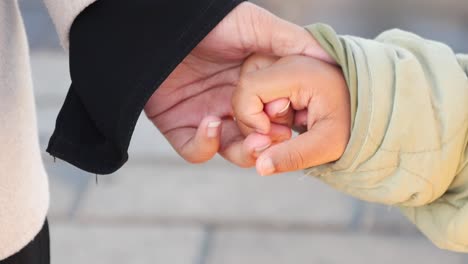 mother and child holding hands