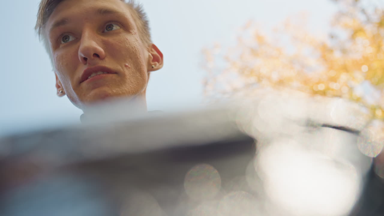 young white courier opening delivery box, POV parcel interior view shows driver checking grocery contents against manifest under autumn trees, soft bokeh foreground, sunlight flare, careful hands