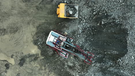 damaged excavator and dump truck at quarry site