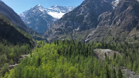 a dynamic aerial shot moving towards the beautiful mountains of the italian piemont region, southern alps