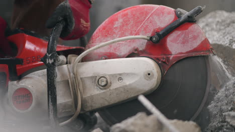 cropped view of laborer working on the road with asphalt cutter