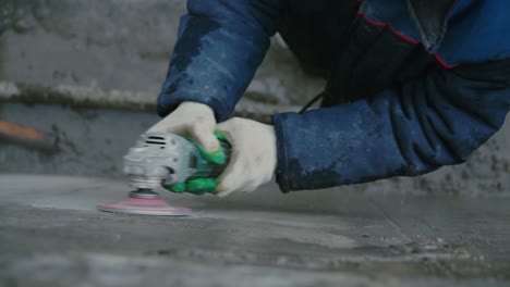 worker grinding concrete floor