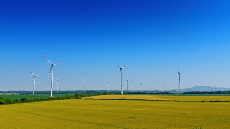 wind turbines in green fields. wind turbines stand tall in expansive green fields under a clear blue sky, showcasing renewable energy initiatives
