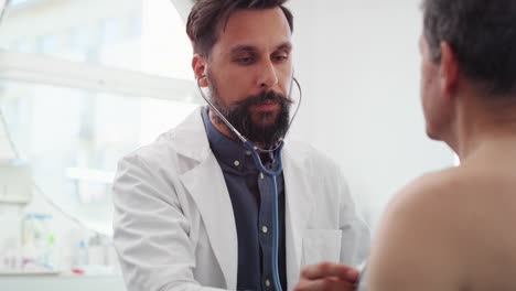 Handheld-view-of-doctor-examining-senior-man