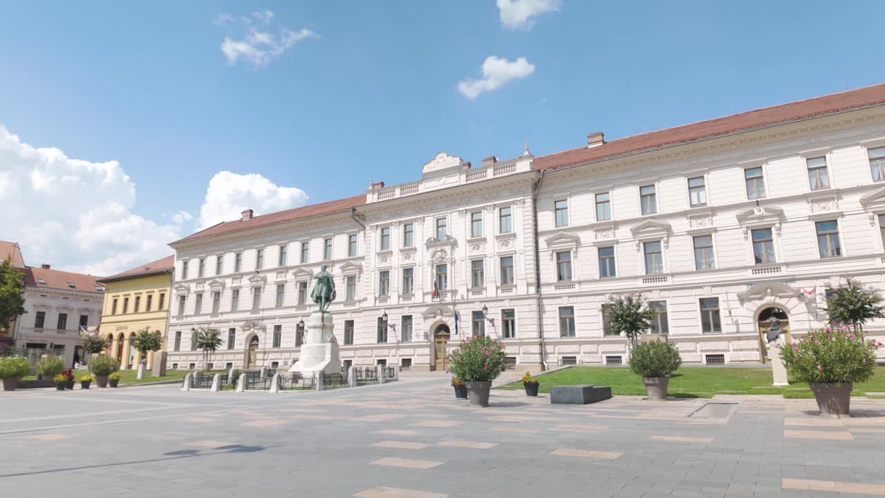 Smooth pan across the government office in Pécs, showcasing historic architecture and urban charm
