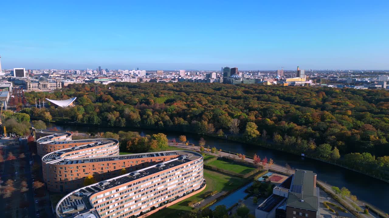 landwehrkanal in berlin, germany, surrounded by buildings and autumn trees on a sunny day. Smooth aerial view flight panorama overview drone