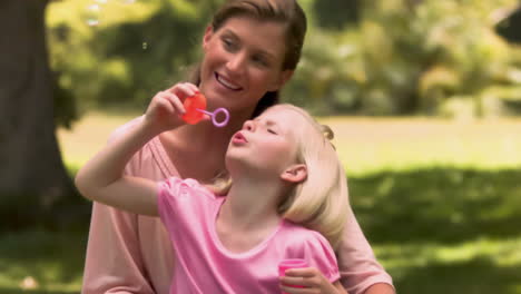 child in slow motion making bubbles