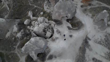 top view of hikers on giant rock formation in cappadocia, turkey