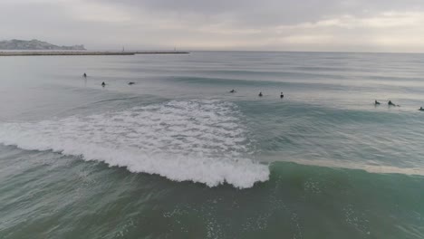 early morning surf session on a cloudy day.