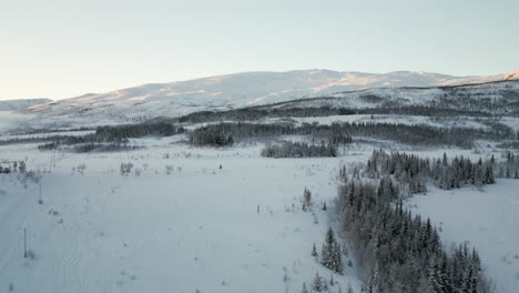 Aerial-riser-panoramic-view-over-snowy-white-winter-landscape-in-Arctic-Kvaloya