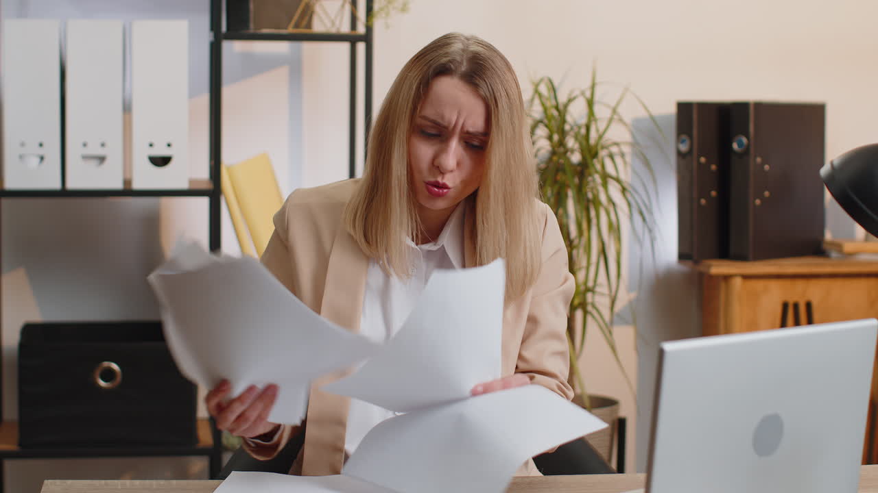 Stressed businesswoman work at unpaid bank debt doing paperwork planning budget throws paper bills