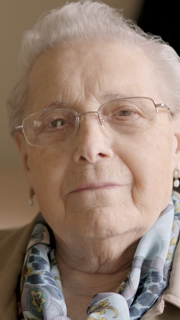 Confident old woman looking at camera sitting in a geriatric