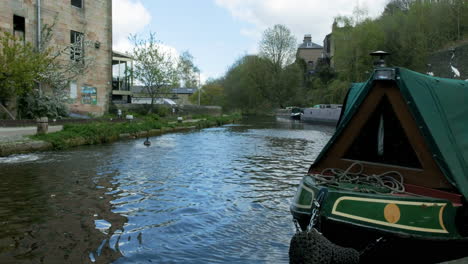 england canal with narrow boats in the spring time with footpath and people uk 4k