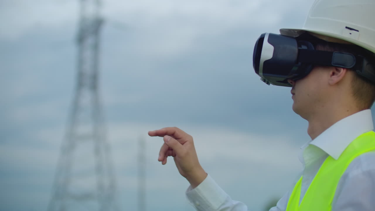 The male engineer manages the transmission of alternative energy from solar panels and wind farms to the consumers of the metropolis. The concept of the modern city.