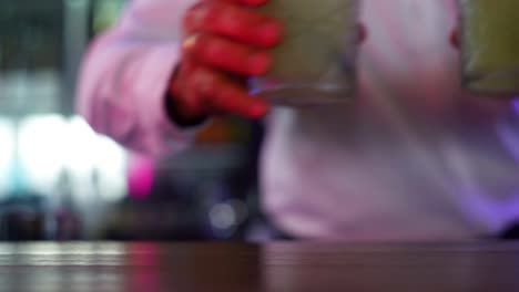 freshly made cocktail drinks grabbed by bartender for guests, close up