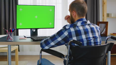 green mockup in front of disabled person