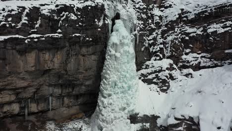 Aerial-view-of-ice-mass-tower-from-frozen-waterfall-in-Ouray-Ice-Park,-Colorado-USA,-drone-shot