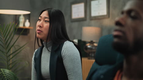 a woman talking to a man in an office