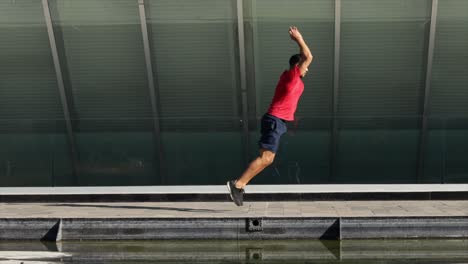 man training jumping outdoors urban landscape