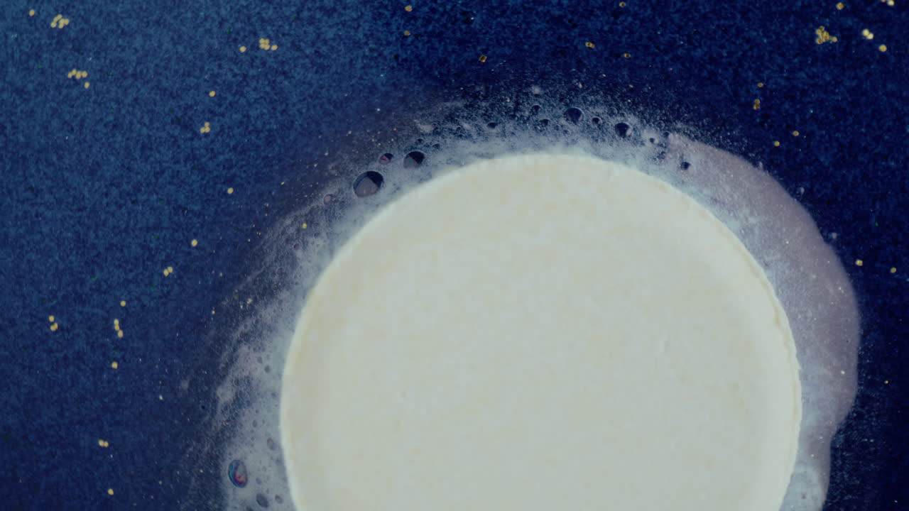 Abstract Circle with Foam on a Blue Surface