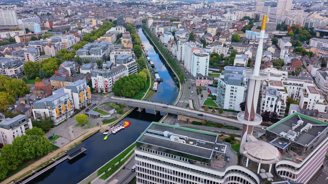 Aerial drone view of Le Mabilay building and Vilaine river in Rennes, France, for travel and urban content