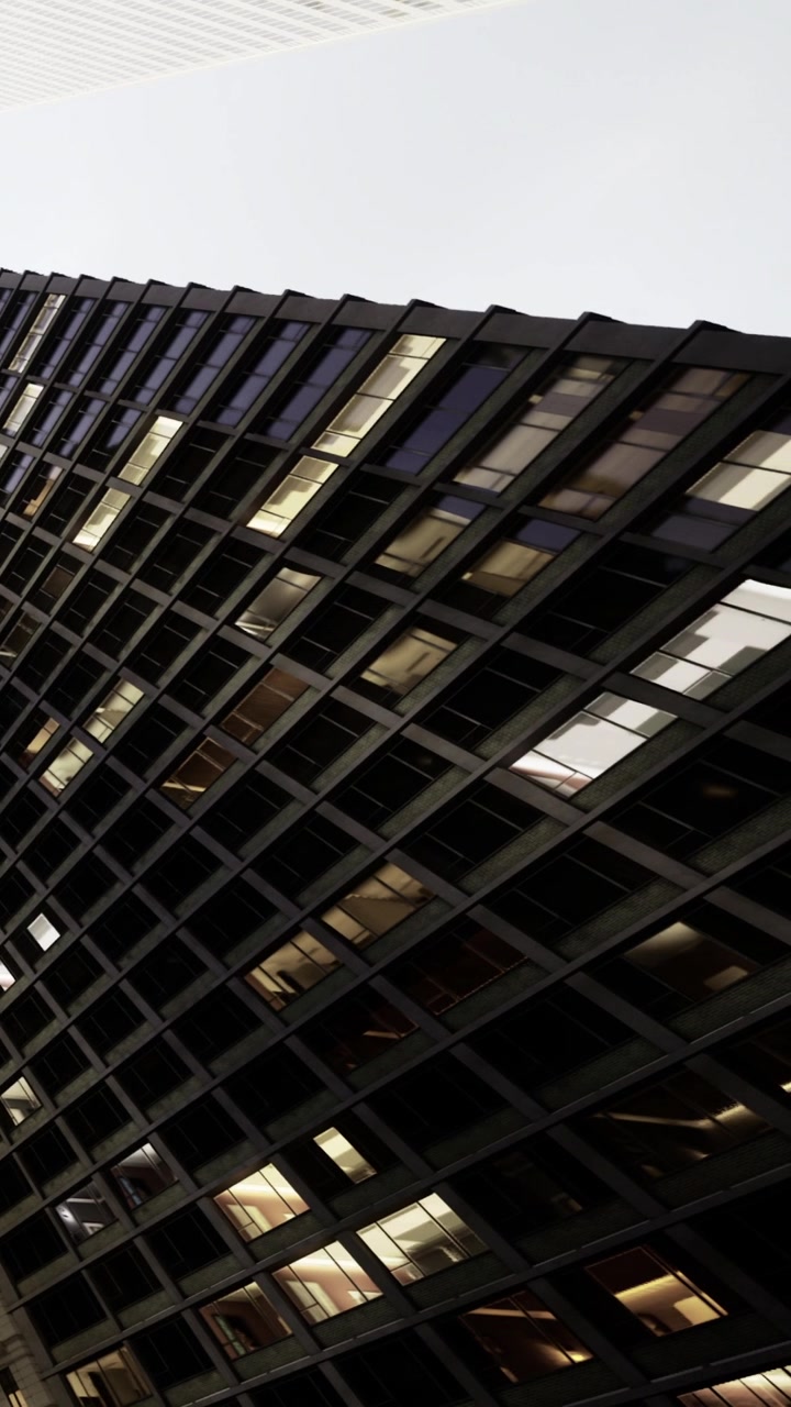 Building with diagonal lines under gray sky at evening time